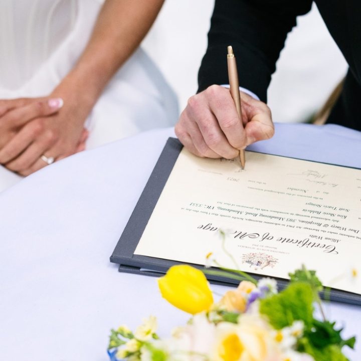 Close up of a couple signing their formal marriage certificate, highlighting a stress-free and legally flawless ceremony in Castlemaine.